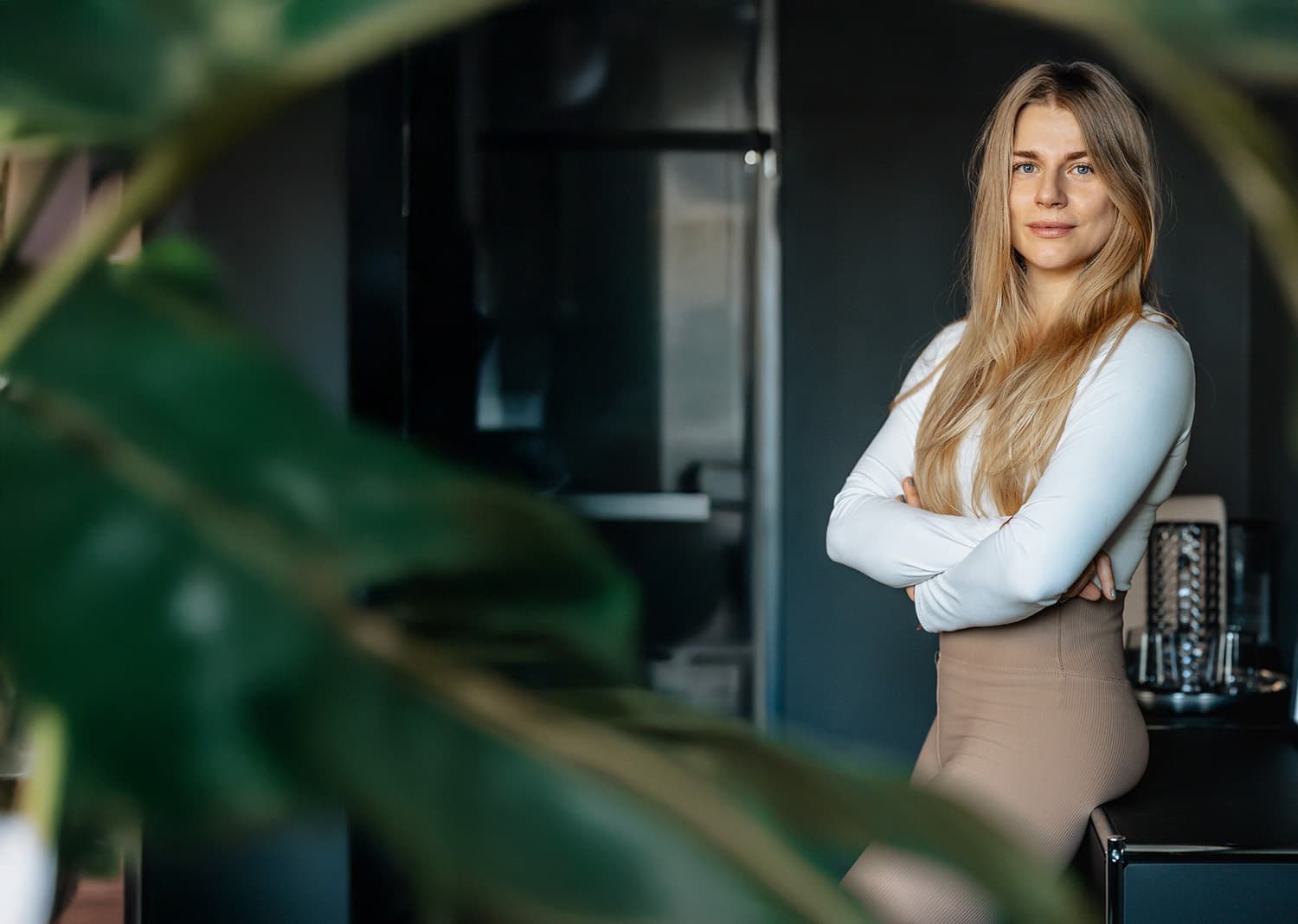 Confident Portrait in Modern Interior Woman with crossed arms standing confidently in a modern indoor space.