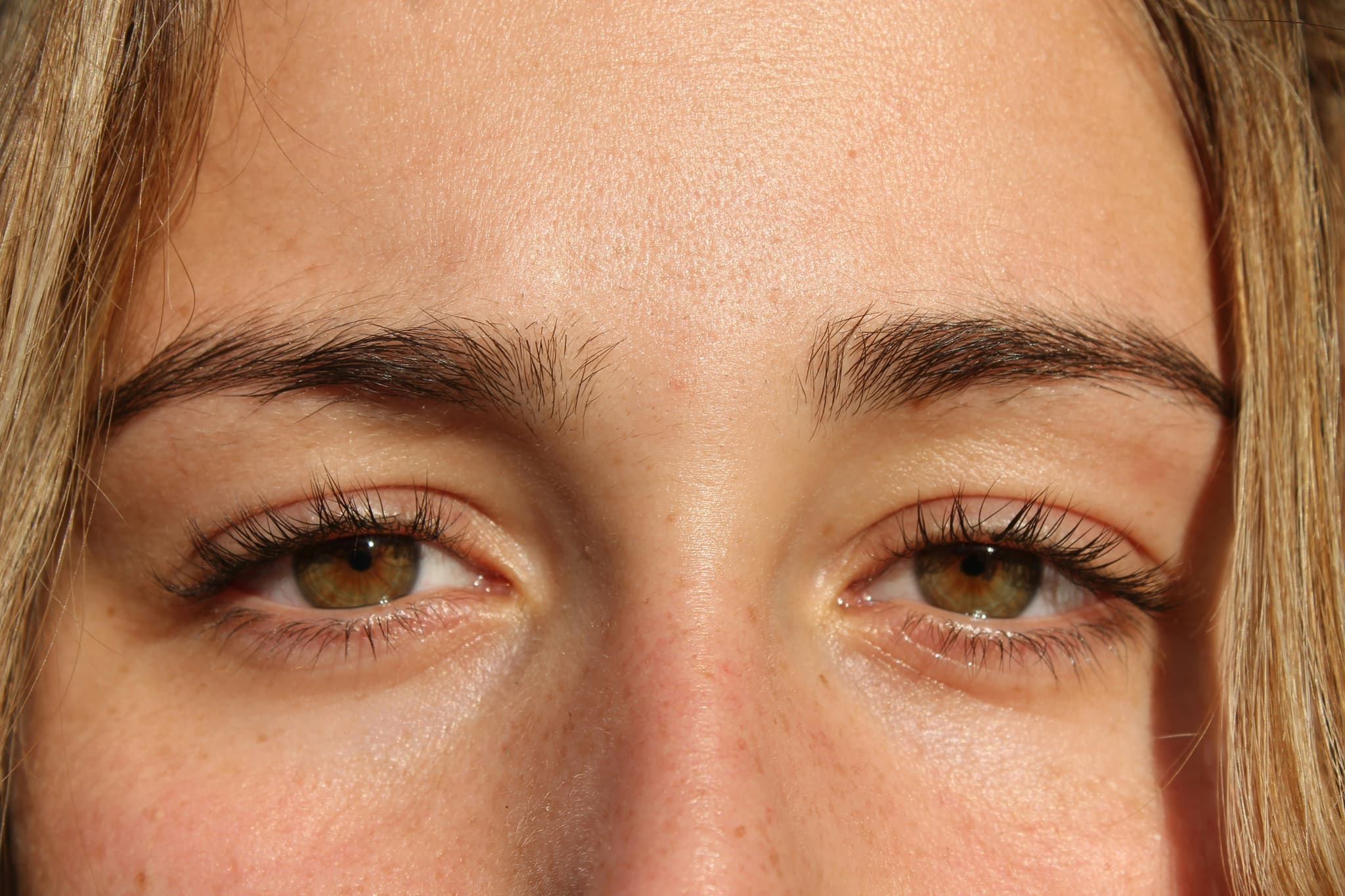Close-Up Eyes With Eyeshadow Close-up of a person's eyes with brown eyeshadow, defined eyebrows, and dark mascara.