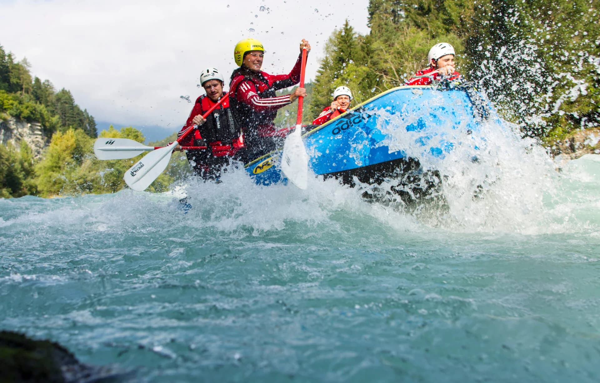 Rafting Team in Action Rafting team paddling through splashing rapids on a river.